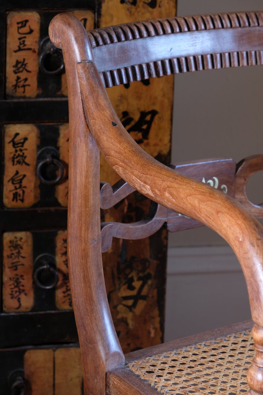 curved arm on a Pair of Regency mahogany armchairs with brass inlay and cane seats, circa 1810