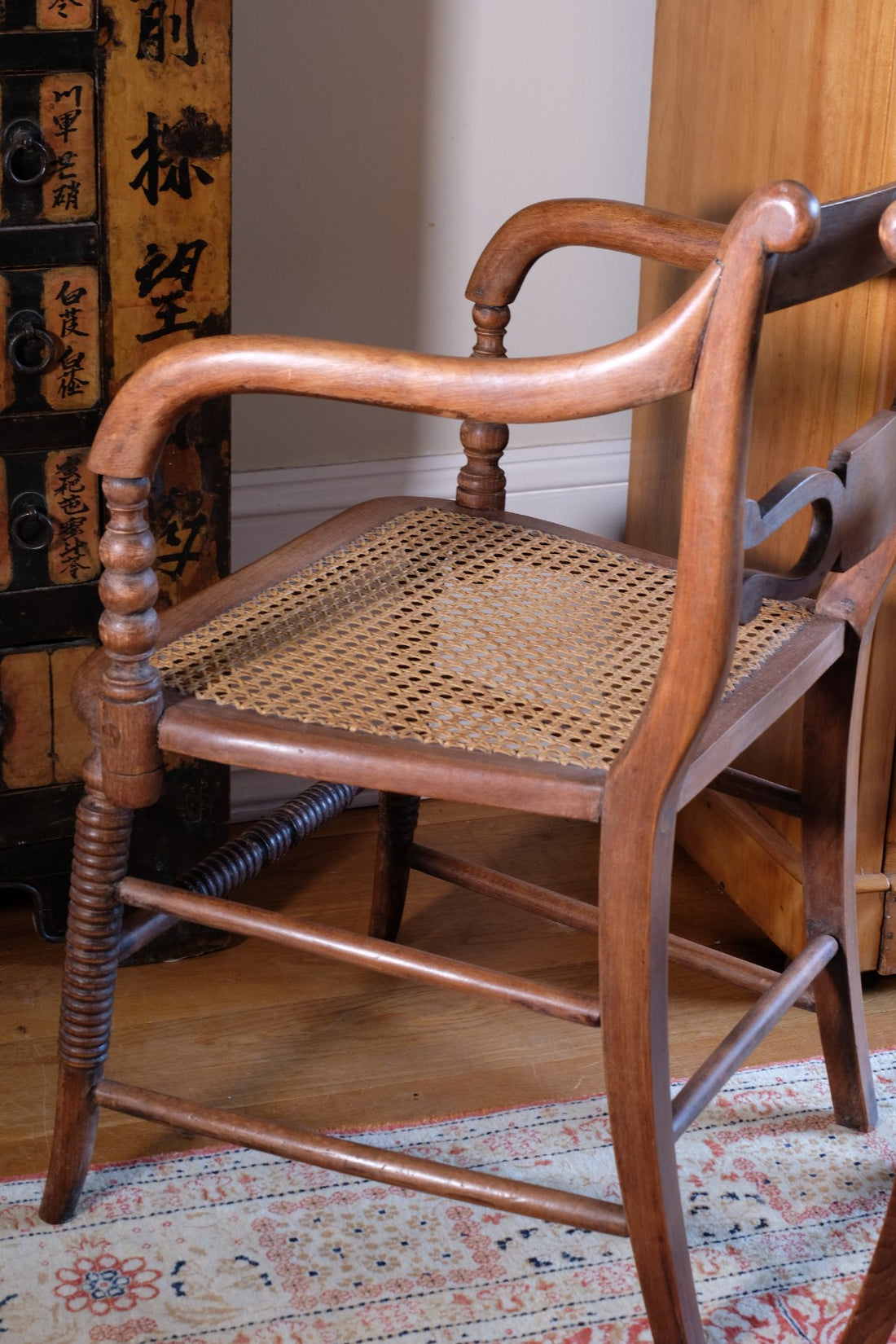 Pair of Regency mahogany armchairs with brass inlay and cane seats, circa 1810