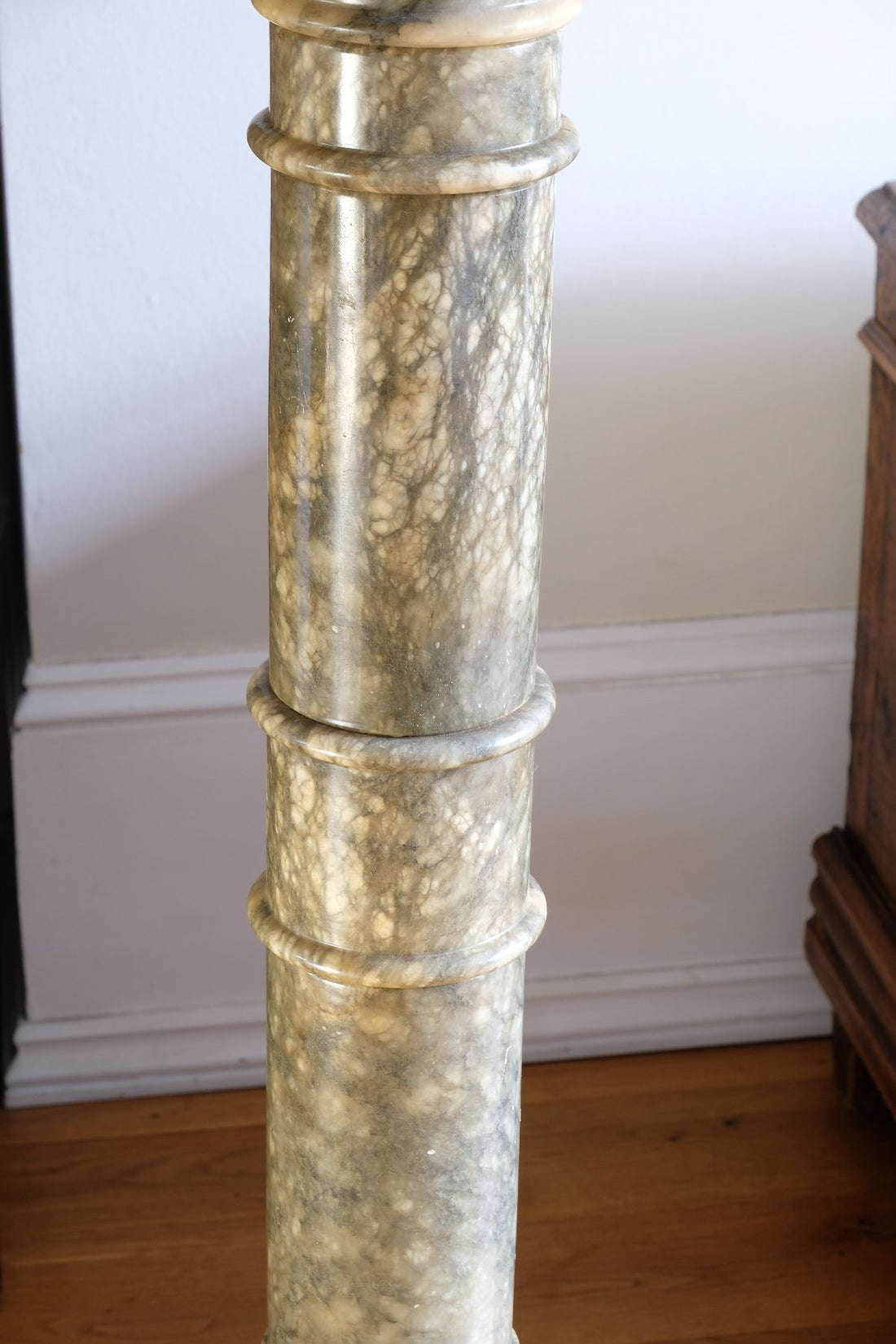Close up of an Antique Verd Antique green brecciated marble pedestal column Victorian display stand