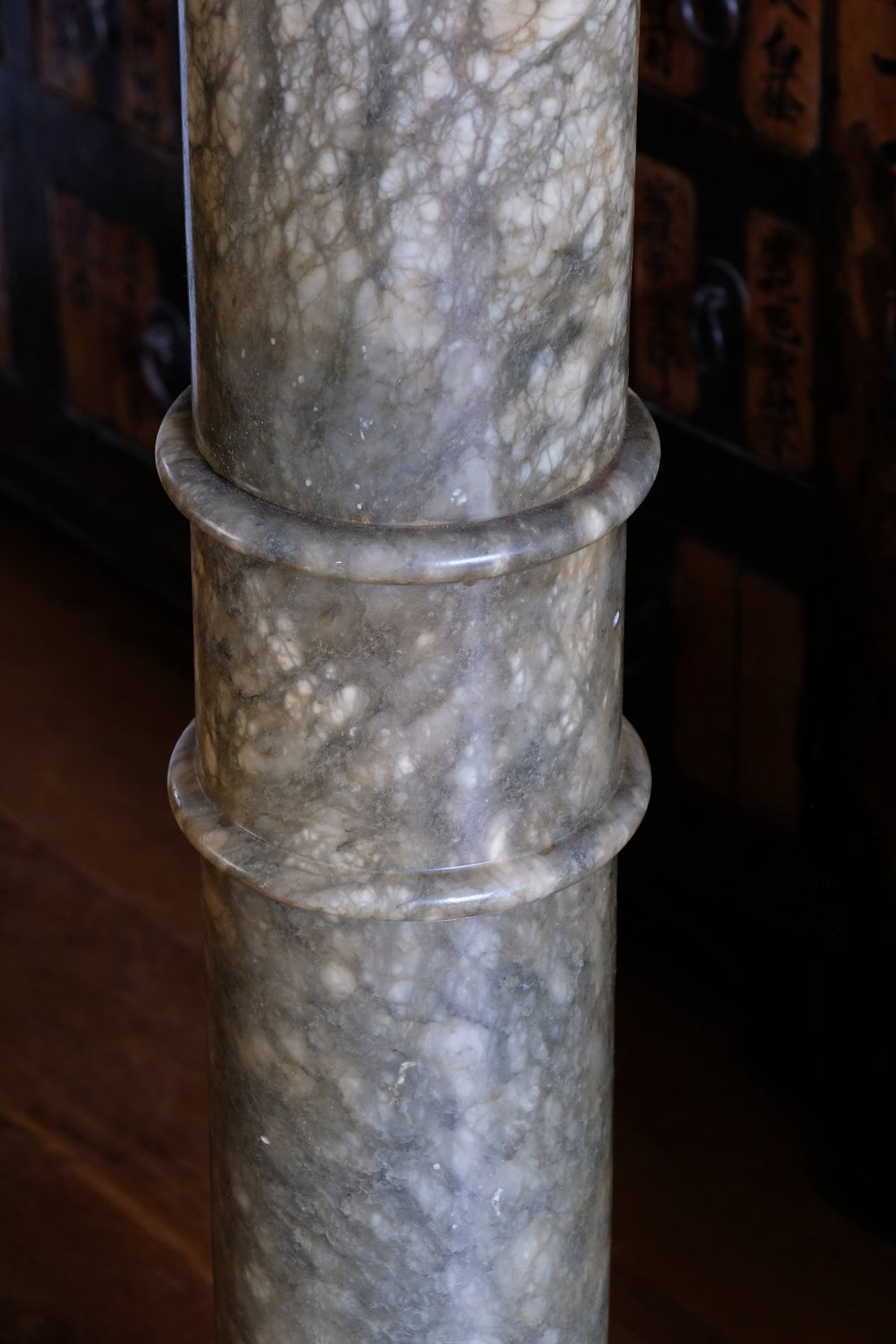 close up of an Antique Verd Antique green brecciated marble pedestal column Victorian display stand