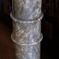 close up of an Antique Verd Antique green brecciated marble pedestal column Victorian display stand