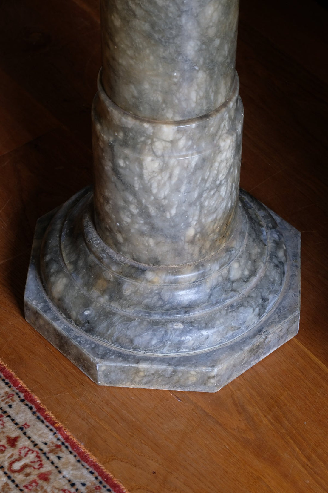 Base close up of an Antique Verd Antique green brecciated marble pedestal column Victorian display stand