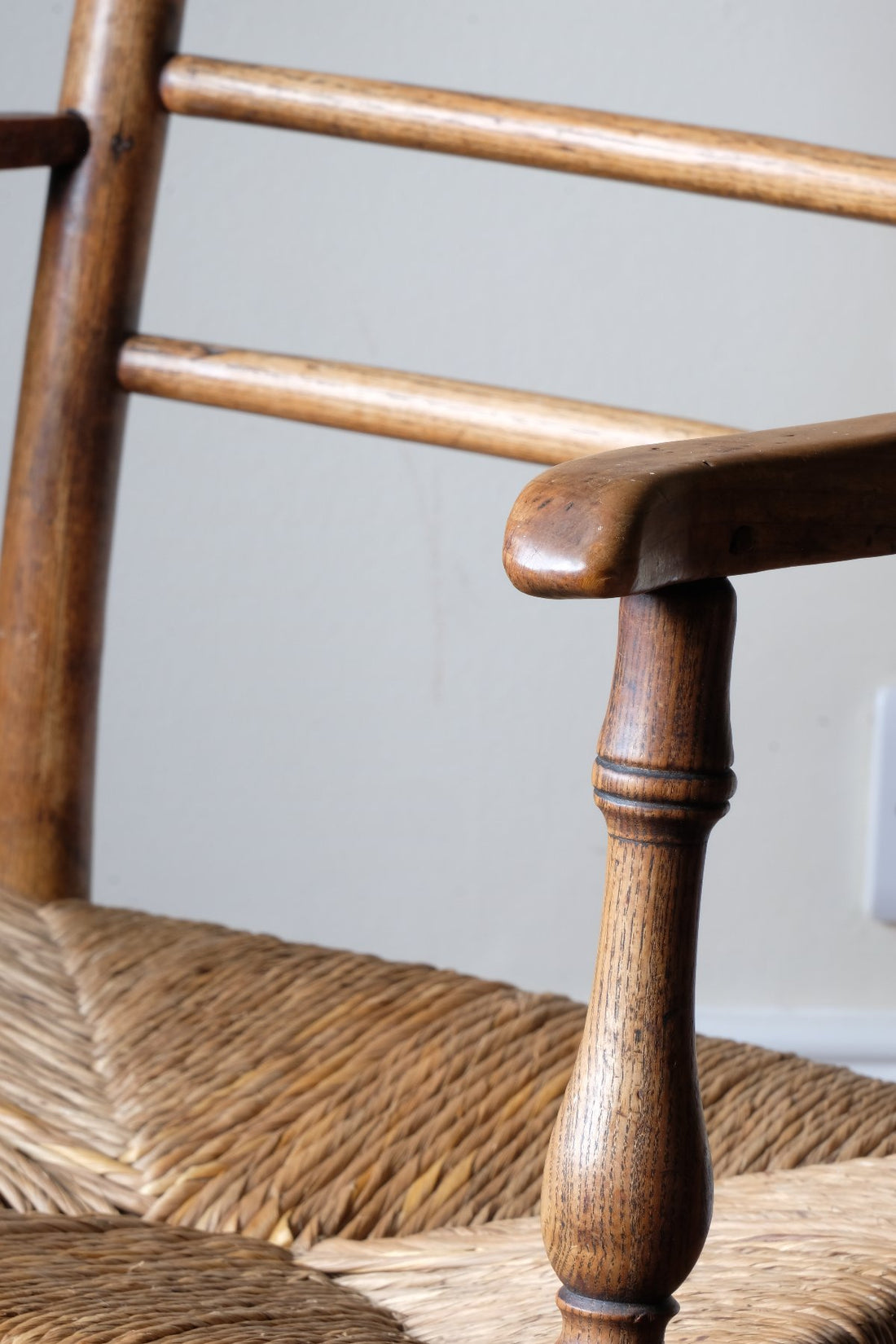 Turned arm supports on the Philip Clissett Arts & Crafts Ash Rush Seat Spindle Back Armchair Circa 1890Philip Clissett Arts & Crafts Ash Rush Seat Spindle Back Armchair Circa 1890