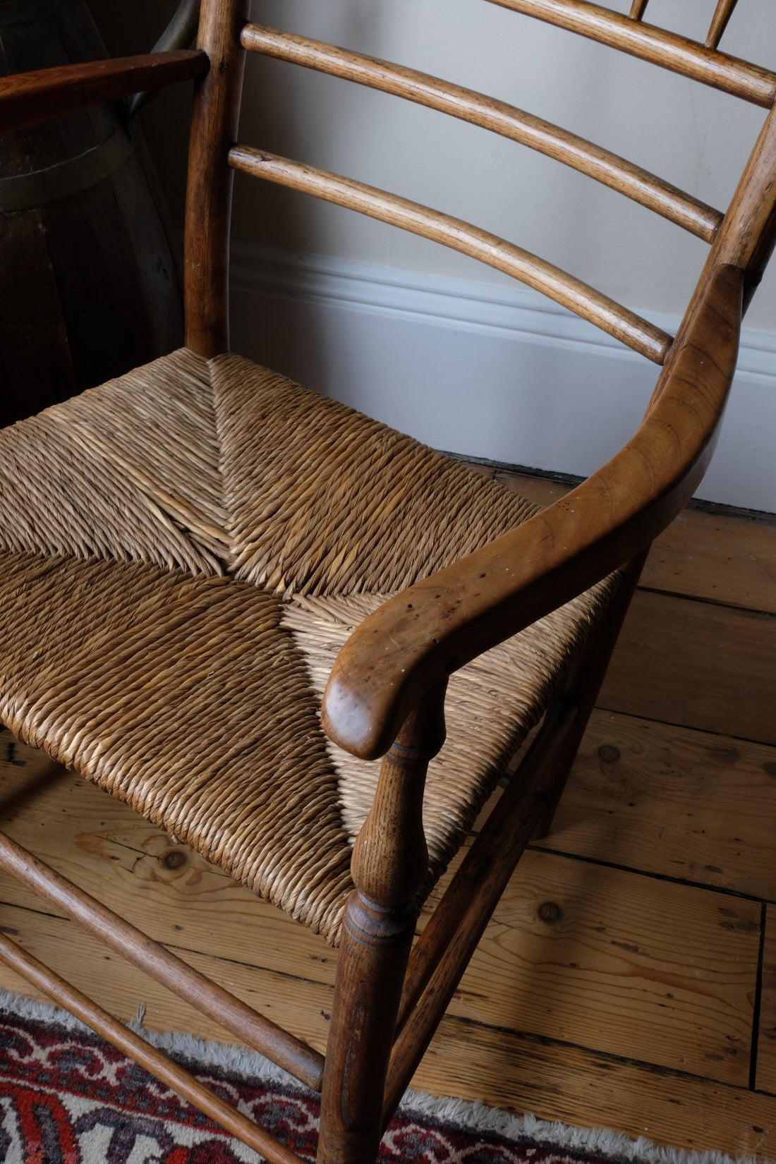 Seat and arm view of a Philip Clissett Arts & Crafts Ash Rush Seat Spindle Back Armchair Circa 1890Philip Clissett Arts & Crafts Ash Rush Seat Spindle Back Armchair Circa 1890