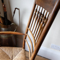 View of a Curved shape cack of a Philip Clissett Arts & Crafts Ash Rush Seat Spindle Back Armchair Circa 1890