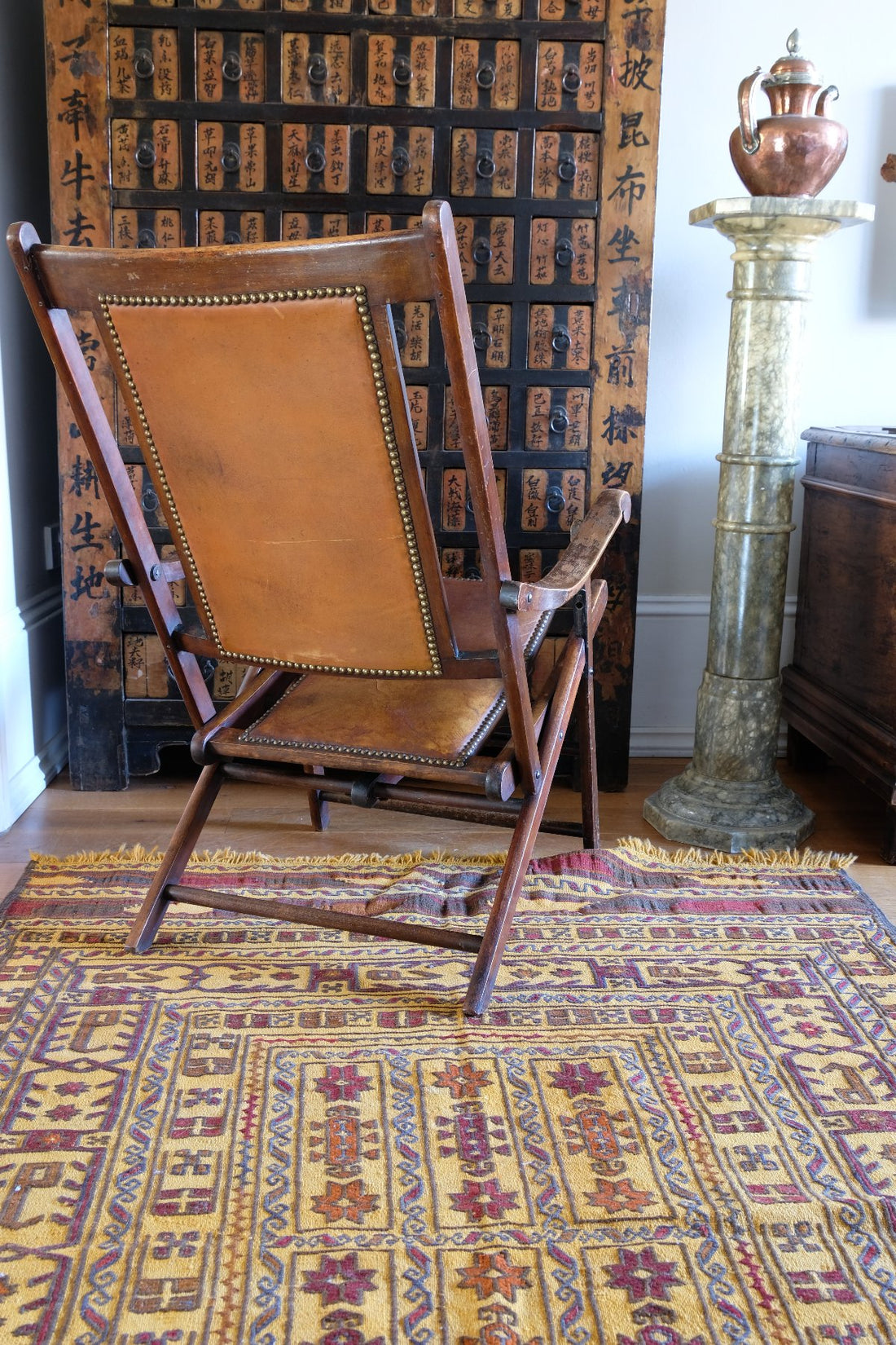 Back view of a Victorian brass studded leather folding campaign chair reclining armchair circa 1875