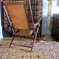 Back view of a Victorian brass studded leather folding campaign chair reclining armchair circa 1875