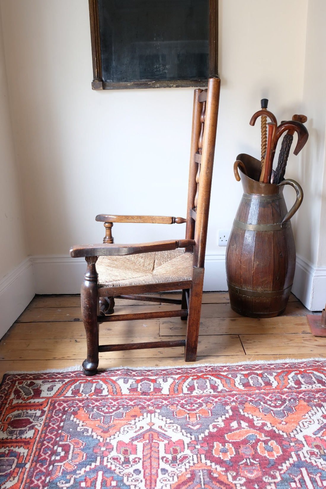 side view baluster-turned leg with a pad foot on a Antique Lancashire Oak Spindle Back Armchair with Rush Seat, 19th Century North Country Chair