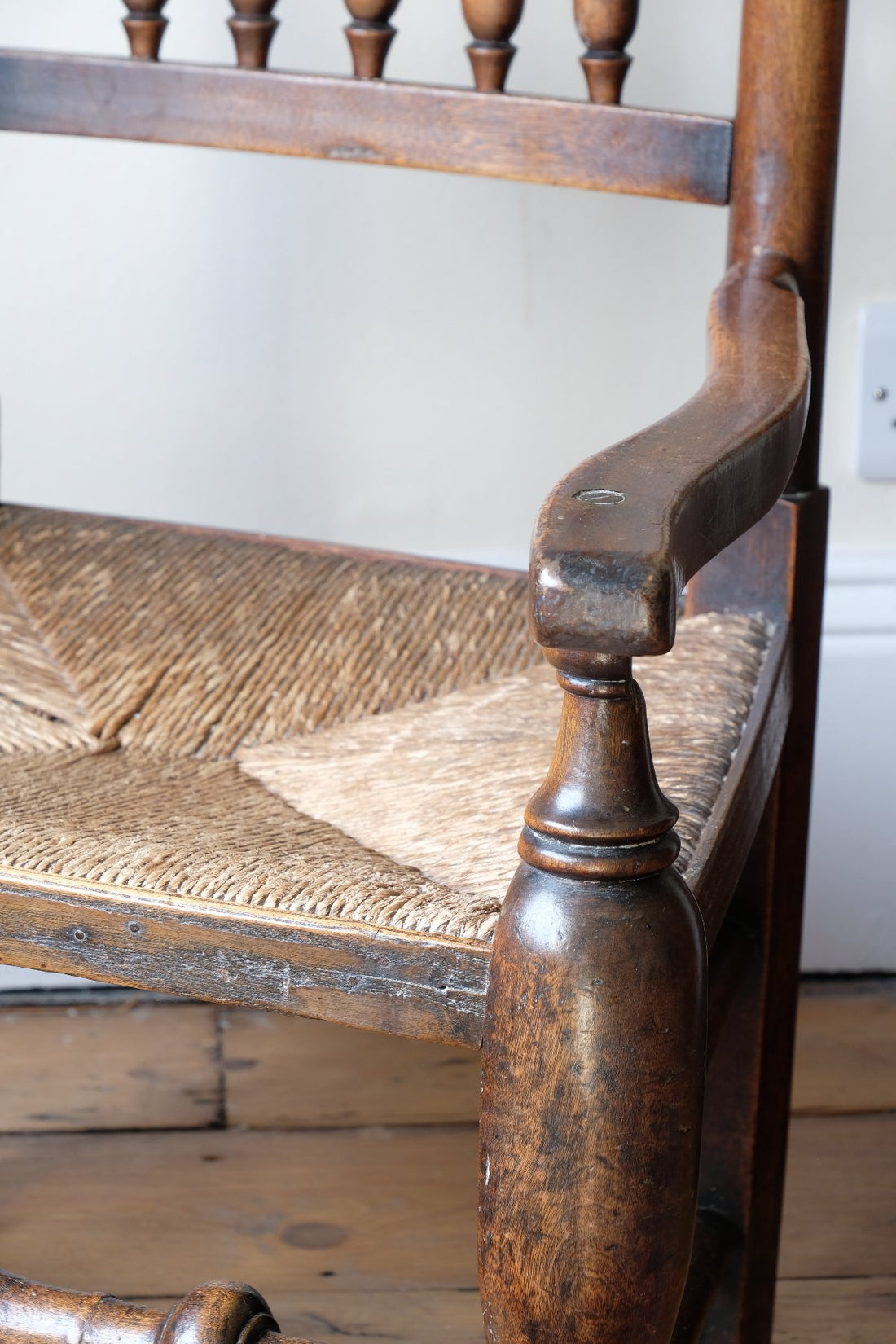 Serpentine armrest on a Antique Lancashire Oak Spindle Back Armchair with Rush Seat, 19th Century North Country Chair