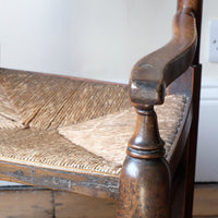 Serpentine armrest on a Antique Lancashire Oak Spindle Back Armchair with Rush Seat, 19th Century North Country Chair