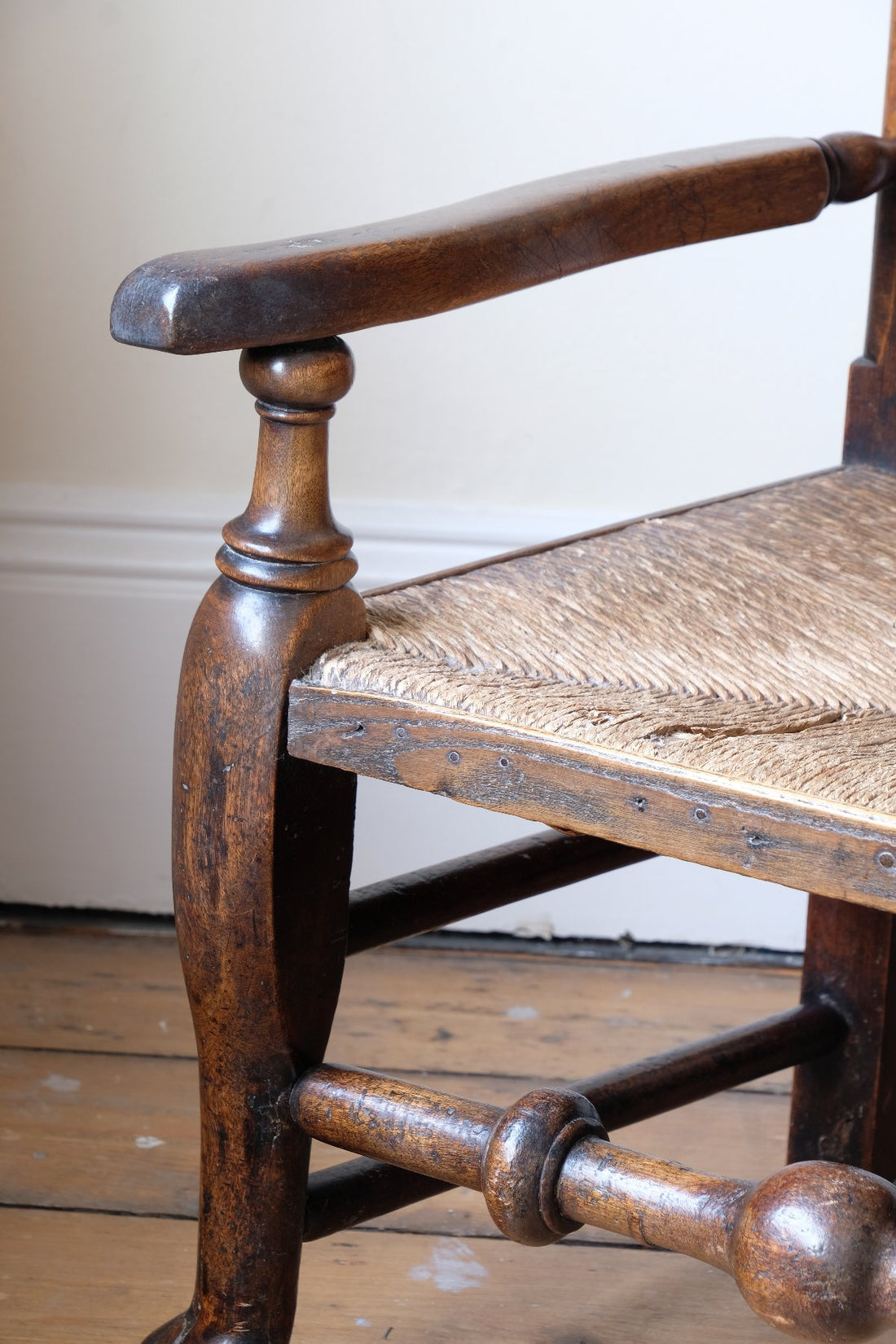 baluster-turned leg with a pad foot on a Antique Lancashire Oak Spindle Back Armchair with Rush Seat, 19th Century North Country Chair