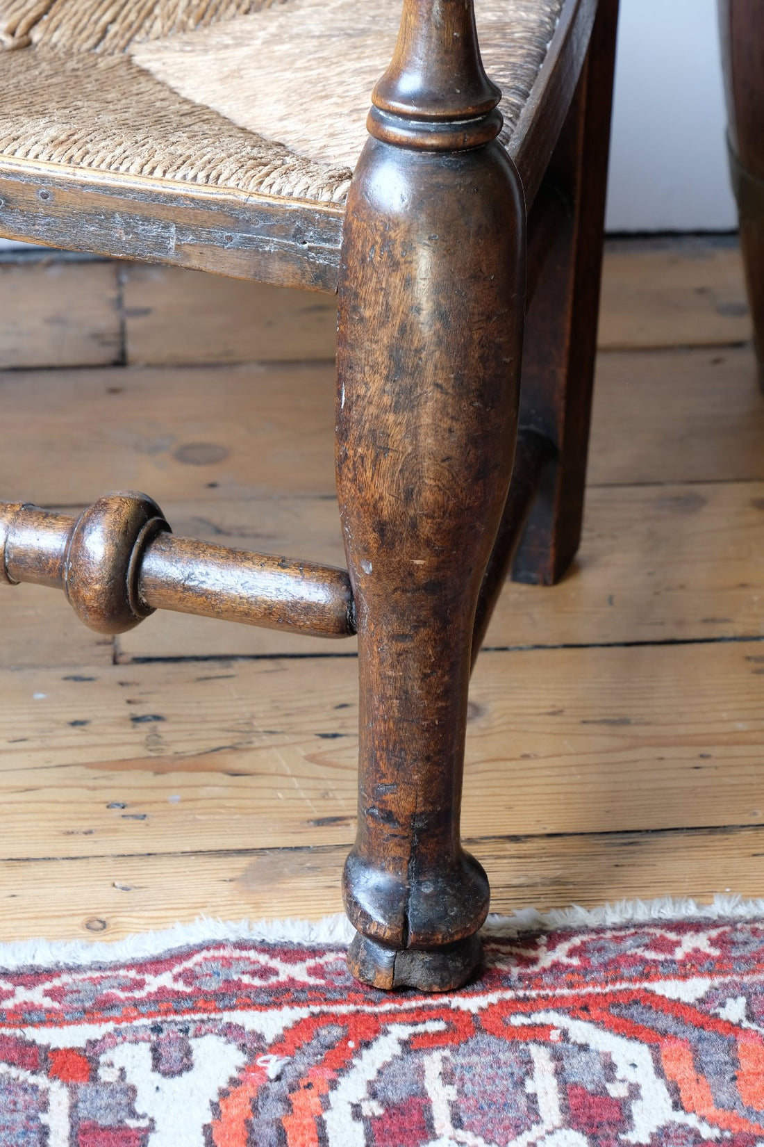 baluster-turned leg with a pad foot on a Antique Lancashire Oak Spindle Back Armchair with Rush Seat, 19th Century North Country Chair