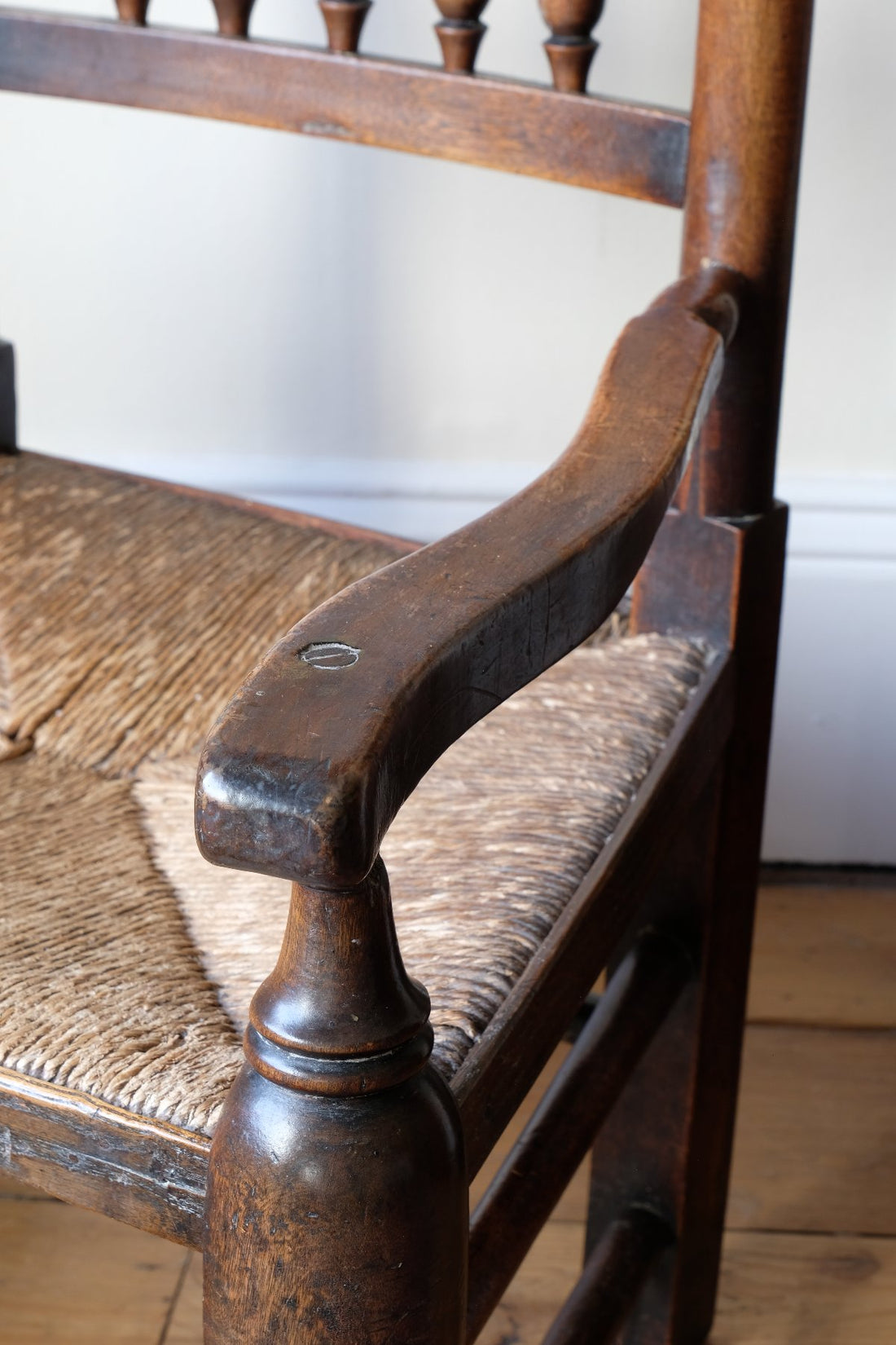 Serpentine arm on an Antique Lancashire Oak Spindle Back Armchair with Rush Seat, 19th Century North Country Chair