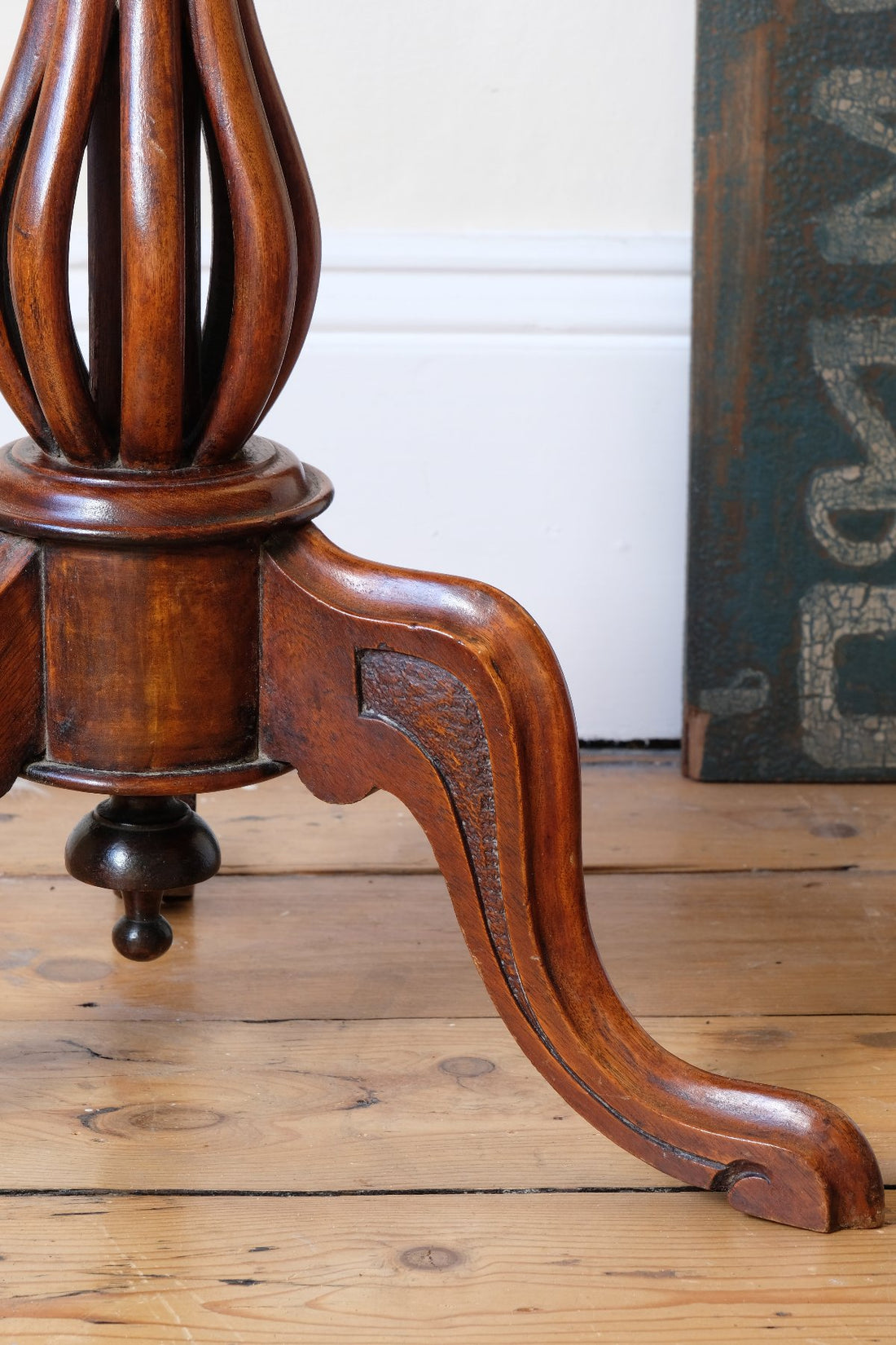carved cabriole legs on a Late Victorian mahogany oval tilt-top tripod table with open reed column detail
