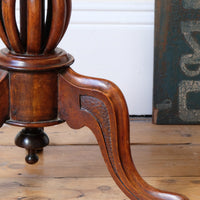 carved cabriole legs on a Late Victorian mahogany oval tilt-top tripod table with open reed column detail