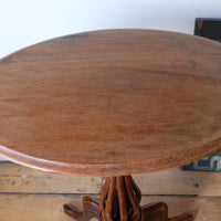 close up of the top on a Late Victorian mahogany oval tilt-top tripod table with open reed column detail