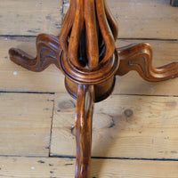 Downward view on a Late Victorian mahogany oval tilt-top tripod table with open reed column detail