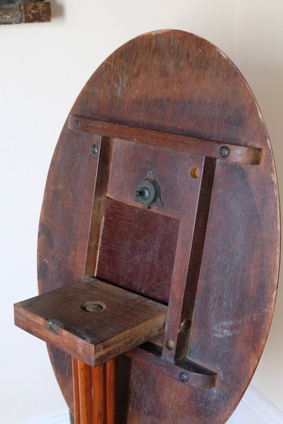 brass latch on a Late Victorian mahogany oval tilt-top tripod table with open reed column detail