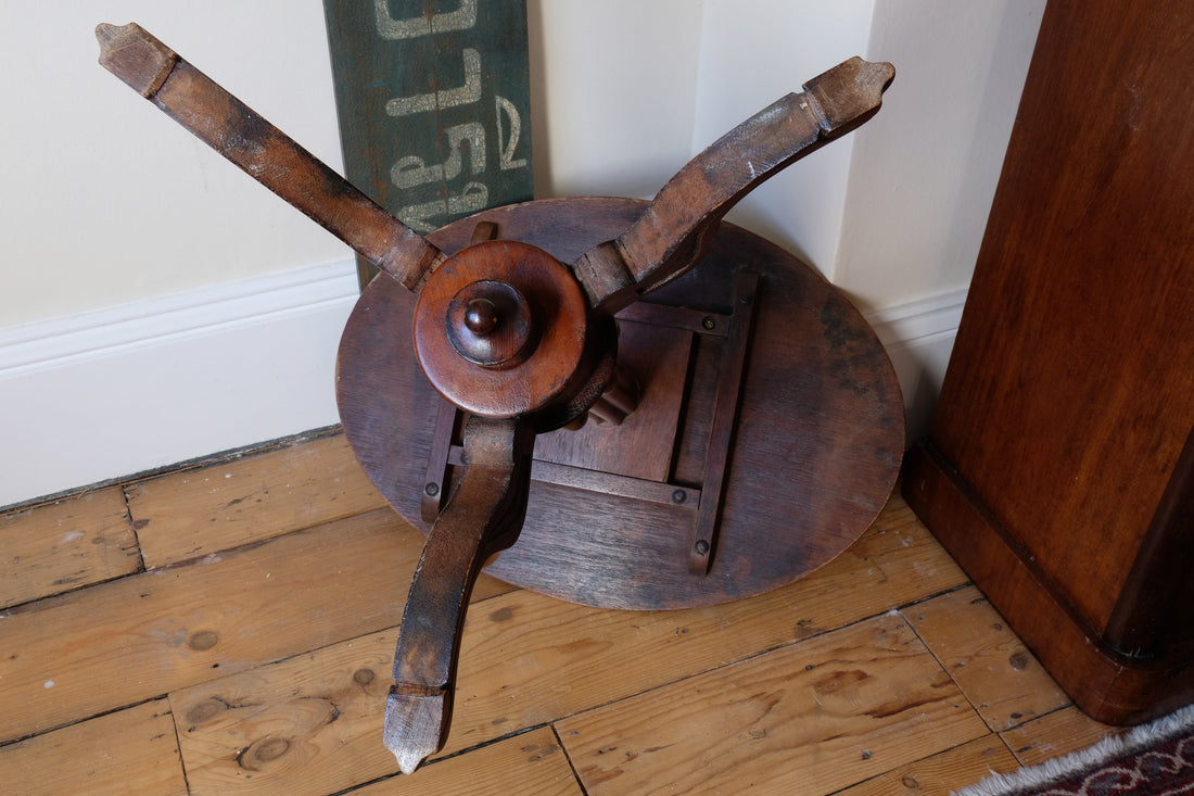 underneath of a Late Victorian mahogany oval tilt-top tripod table with open reed column detail