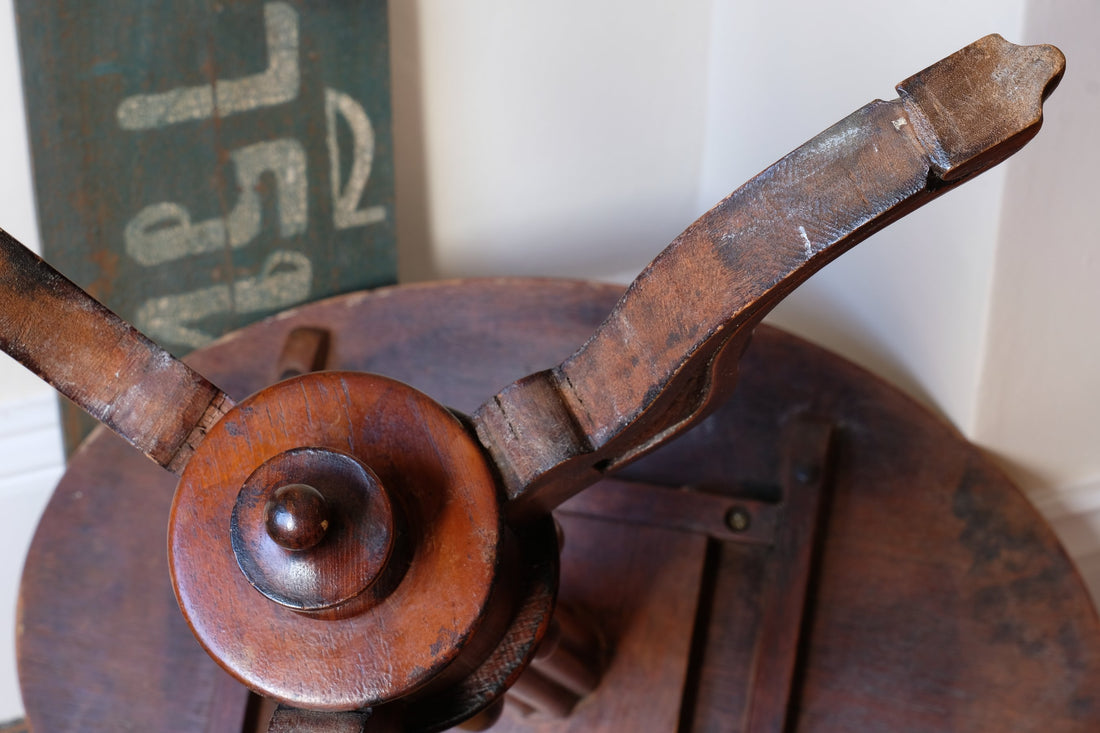Underneath of a Late Victorian mahogany oval tilt-top tripod table with open reed column detail
