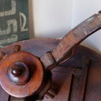 Underneath of a Late Victorian mahogany oval tilt-top tripod table with open reed column detail