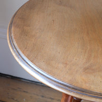 Edge profile moulding of the Victorian mahogany cricket table with faux bamboo legs and two-tone finish