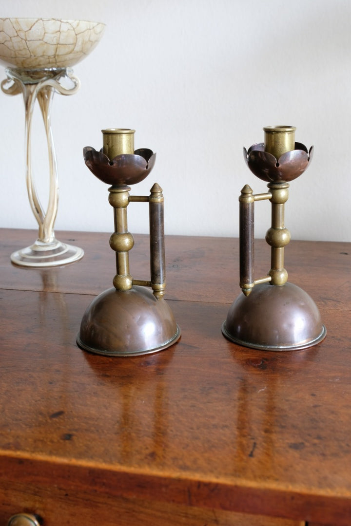 Arts & Crafts copper and brass candlestick pair with patina