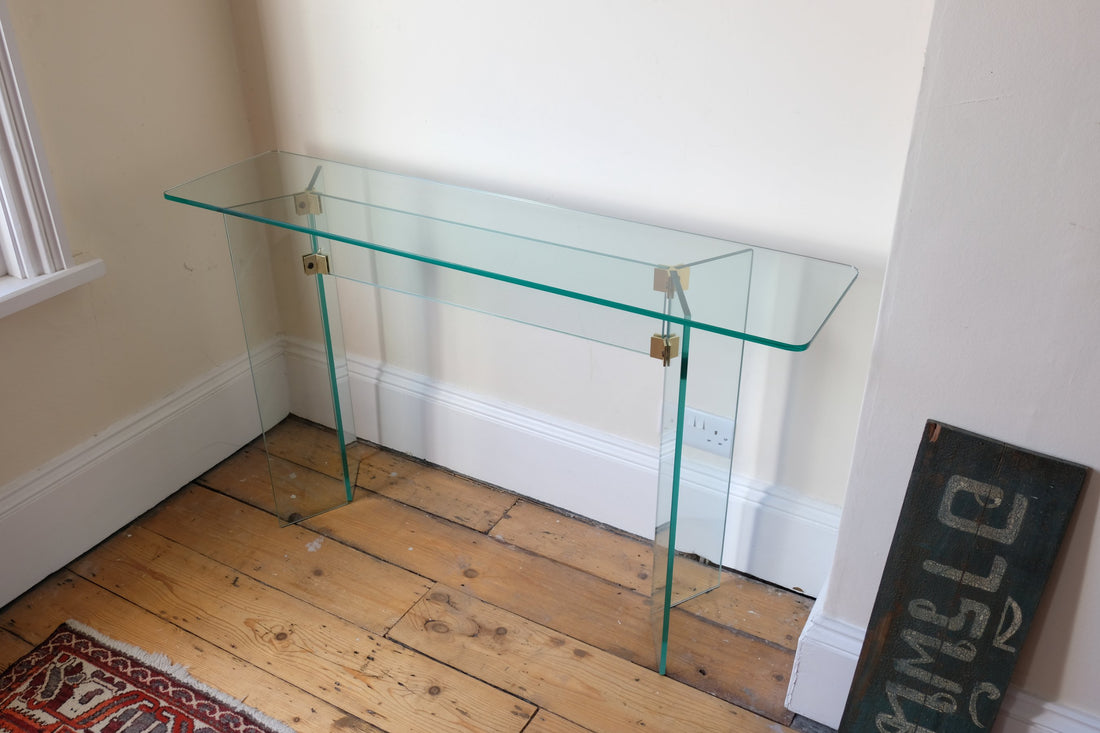 Top view - Modern glass hall table with sculptural metal V-shaped base in Leon Rosen style
