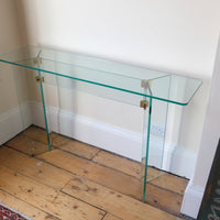 Top view - Modern glass hall table with sculptural metal V-shaped base in Leon Rosen style