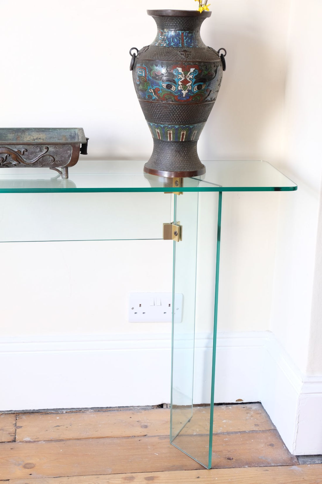 Modern glass hall table with sculptural metal V-shaped base in Leon Rosen style