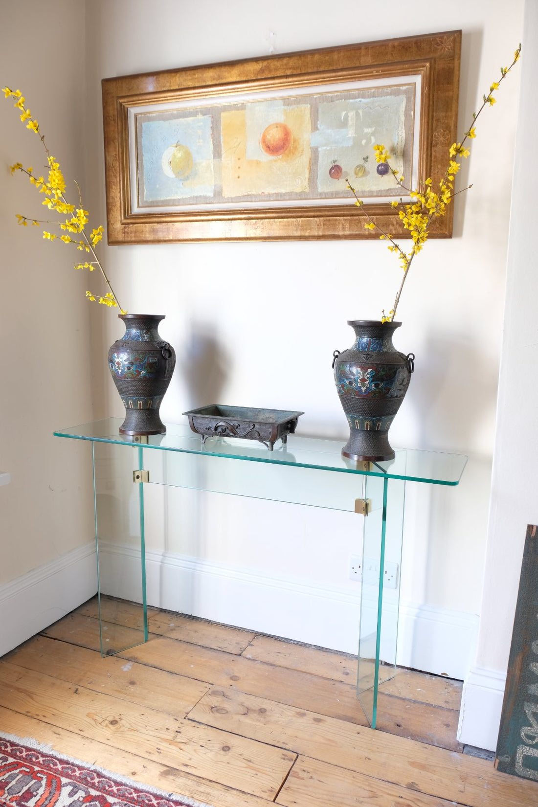 Modern glass hall table with sculptural metal V-shaped base in Leon Rosen style