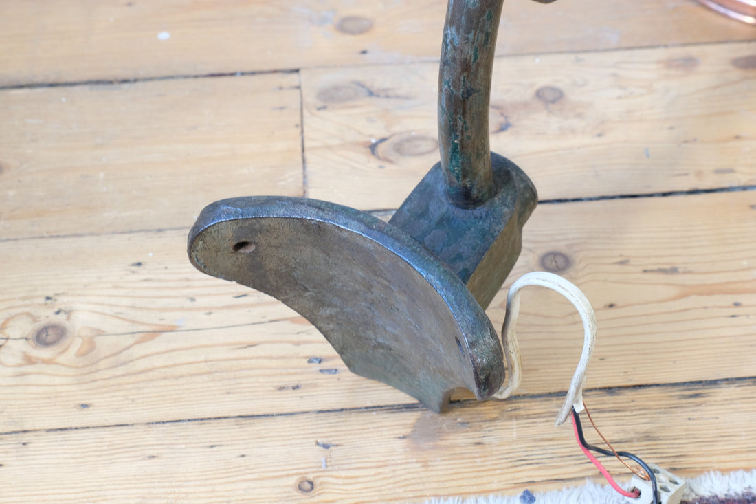 Curved back of the mounting plate on a 1930s Revo Tipton cast iron and copper swan neck street lamp