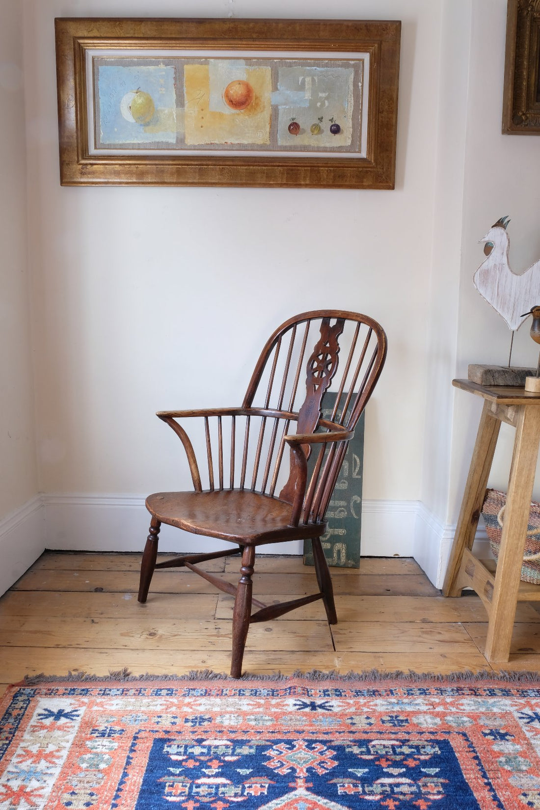 Antique English Windsor armchair in elm with uneven seat and ash stick back