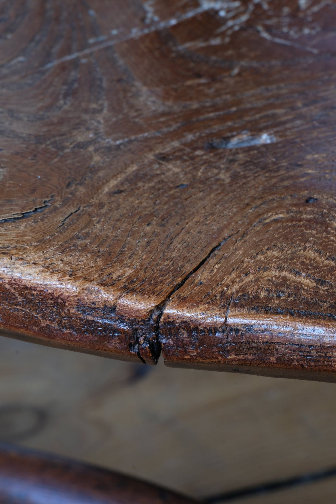 close up of the old timber seat - Antique English Windsor armchair in elm with uneven seat and ash stick back