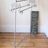 Early 20th century wrought iron freestanding towel rail with scroll ends and aged painted finish