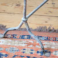 Cloe up of feet and legs - Early 20th century wrought iron freestanding towel rail with scroll ends and aged painted finish