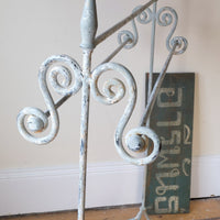 Early 20th century wrought iron freestanding towel rail with scroll ends and aged painted finish