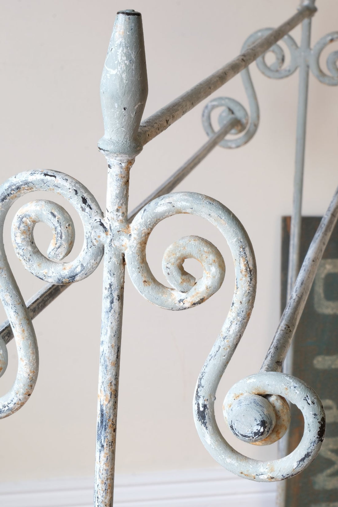 close up of pait work - Early 20th century wrought iron freestanding towel rail with scroll ends and aged painted finish