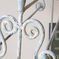 close up of pait work - Early 20th century wrought iron freestanding towel rail with scroll ends and aged painted finish