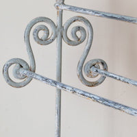 Early 20th century wrought iron freestanding towel rail with scroll ends and aged painted finish