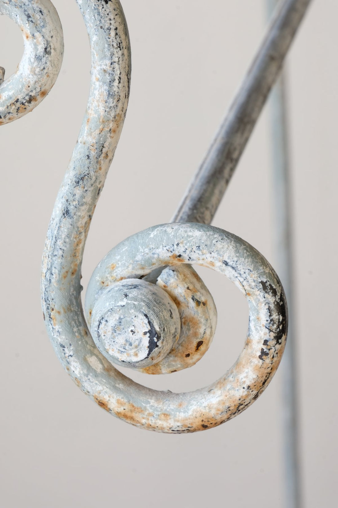 Early 20th century wrought iron freestanding towel rail with scroll ends and aged painted finish
