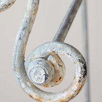 Early 20th century wrought iron freestanding towel rail with scroll ends and aged painted finish