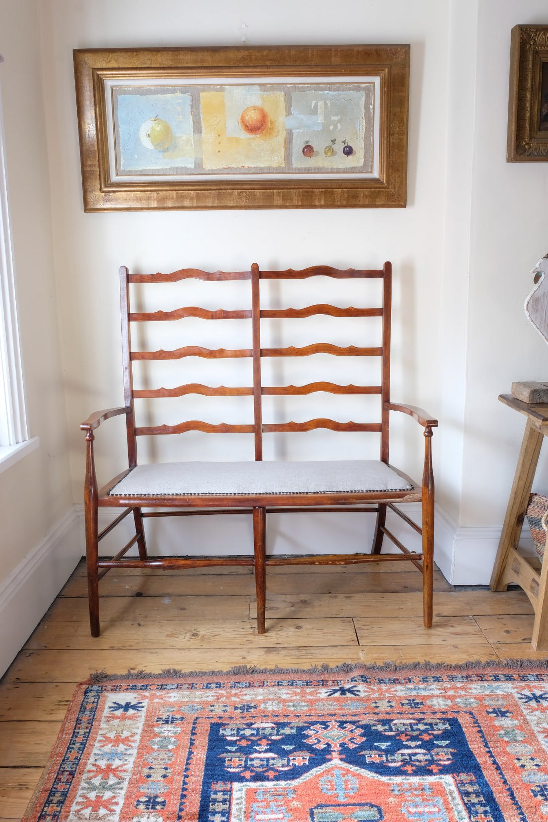 19th century English beech ladder-back bench with linen upholstered horsehair seat and waved slats