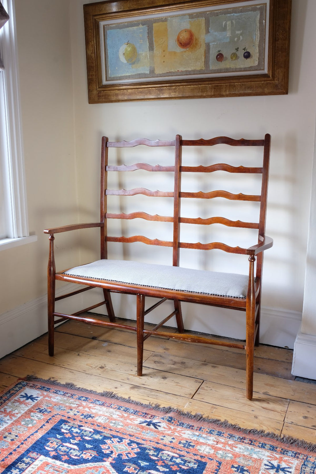 19th century English beech ladder-back bench with linen upholstered horsehair seat and waved slats