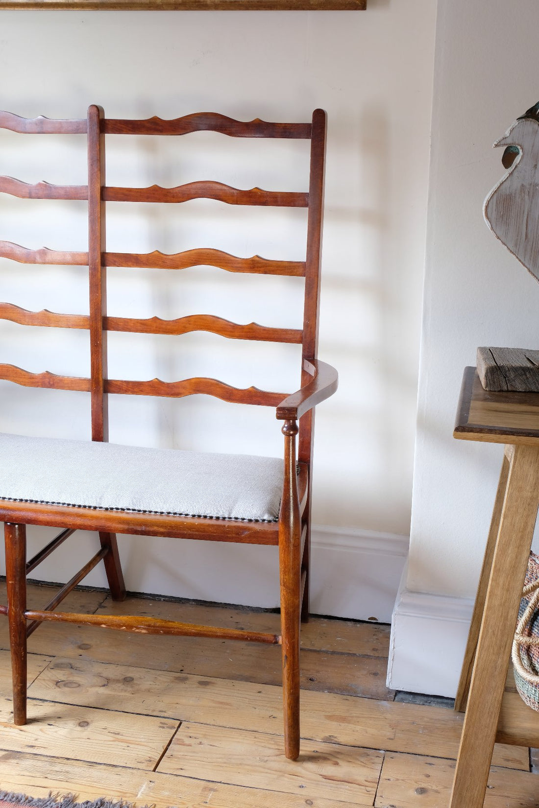 19th century English beech ladder-back bench with linen upholstered horsehair seat and waved slats