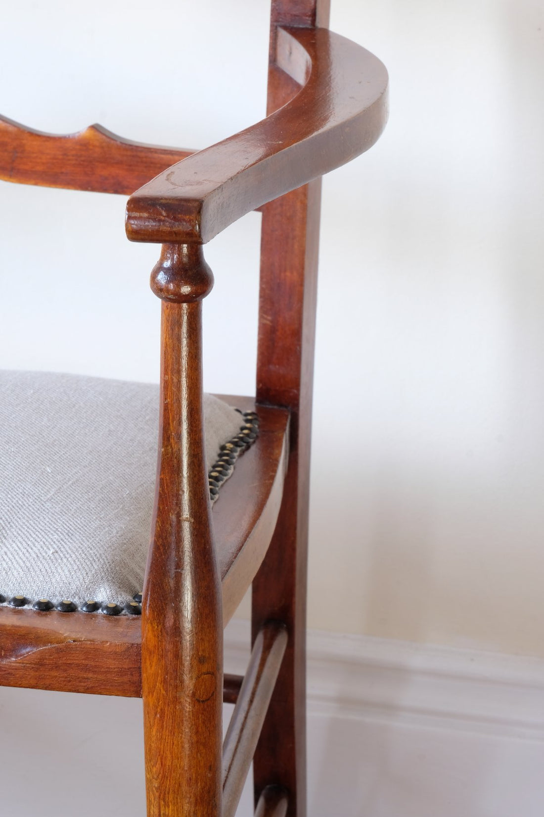 1Turned leg on a 9th century English beech ladder-back bench with linen upholstered horsehair seat and waved slats