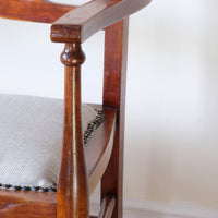 1Turned leg on a 9th century English beech ladder-back bench with linen upholstered horsehair seat and waved slats