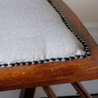 Linen stud work seat on a 19th century English beech ladder-back bench with linen upholstered horsehair seat and waved slats