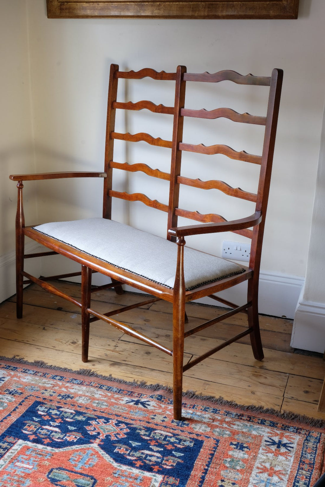 side shot - 19th century English beech ladder-back bench with linen upholstered horsehair seat and waved slats