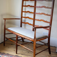 19th century English beech ladder-back bench with linen upholstered horsehair seat and waved slats